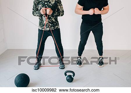 Fitness instructor teaching man using resistance band in studio View Large Photo Image Stock Image - Fitness instructor teaching man using resistance band in studio. Fotosearch