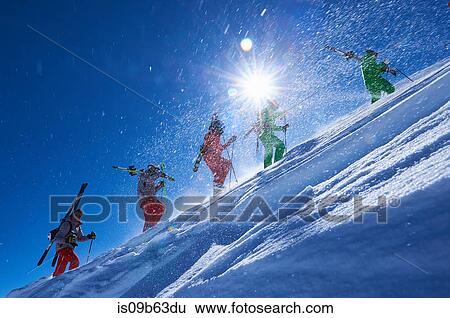 Five male skiers trudging up steep sunlit mountainside, Aspen, Colorado, USA View Large Photo Image Stock Photograph - Five male skiers trudging up steep sunlit mountainside, Aspen, Colorado, USA. Fotosearch