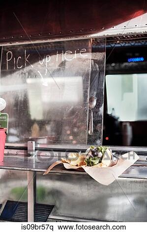 Stock Photography - Food served through window of food truck. Fotosearch