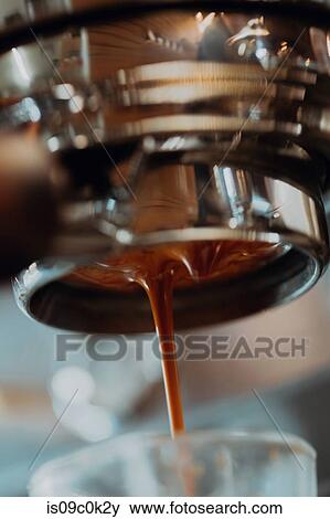 Fresh coffee pouring from coffee machine into drinking glass in cafe, close up View Large Photo Image Stock Photo - Fresh coffee pouring from coffee machine into drinking glass in cafe, close up. Fotosearch