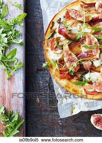 Fresh pizza with rocket leaf and fig, overhead view View Large Photo Image Stock Photography - Fresh pizza with rocket leaf and fig, overhead view. Fotosearch