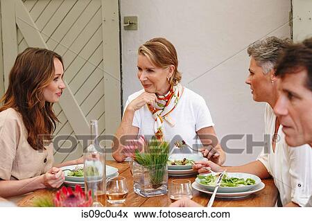 Stock Photo - Friends and family having lunch in restaurant, Cape Town, South Africa. Fotosearch
