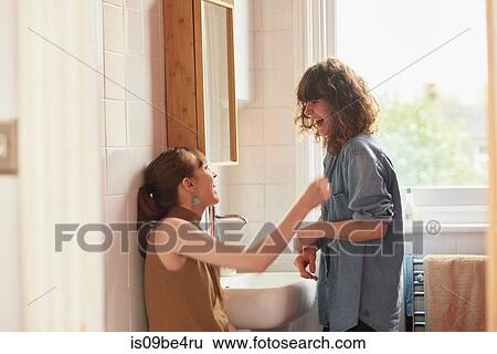 Friends chatting in bathroom View Large Photo Image Stock Photograph - Friends chatting in bathroom. Fotosearch