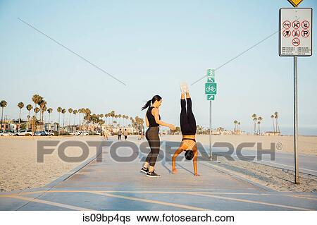 Friends doing exercises by beach, Long Beach, California, US View Large Photo Image Stock Photograph - Friends doing exercises by beach, Long Beach, California, US. Fotosearch