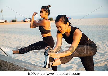 Friends doing exercises on beach, Long Beach, California, US View Large Photo Image Stock Photograph - Friends doing exercises on beach, Long Beach, California, US. Fotosearch