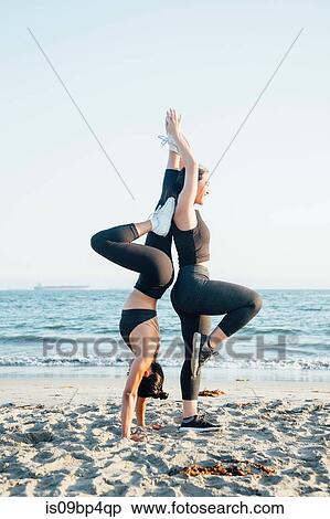 Friends doing exercises on beach View Large Photo Image Stock Photography - Friends doing exercises on beach. Fotosearch