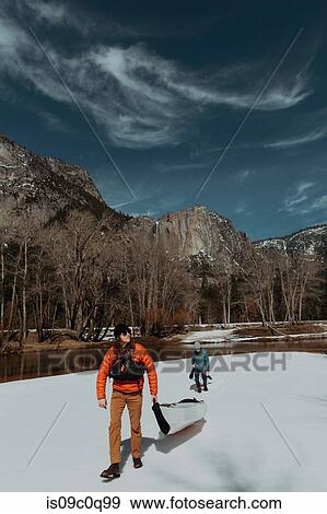 Friends dragging kayak across snow, Yosemite Village, California, United States View Large Photo Image Stock Photo - Friends dragging kayak across snow, Yosemite Village, California, United States. Fotosearch