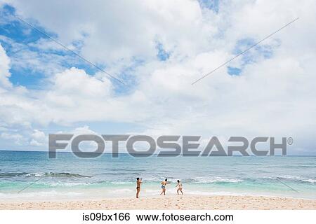 Friends enjoying Sunset Beach, Oahu, Hawaii View Large Photo Image Stock Photograph - Friends enjoying Sunset Beach, Oahu, Hawaii. Fotosearch