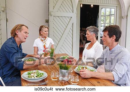 Stock Photograph - Friends having lunch in restaurant, Cape Town, South Africa. Fotosearch