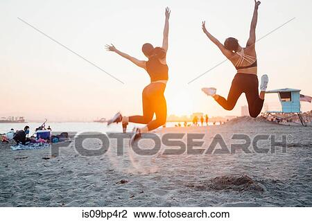 Friends jumping on beach, Long Beach, California, US View Large Photo Image Stock Image - Friends jumping on beach, Long Beach, California, US. Fotosearch