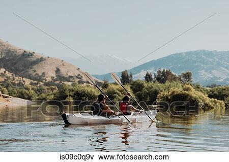 Stock Photo - Friends kayaking in lake, Kaweah, California, United States. Fotosearch
