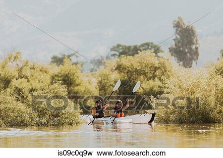 Stock Photo - Friends kayaking in lake, Kaweah, California, United States. Fotosearch
