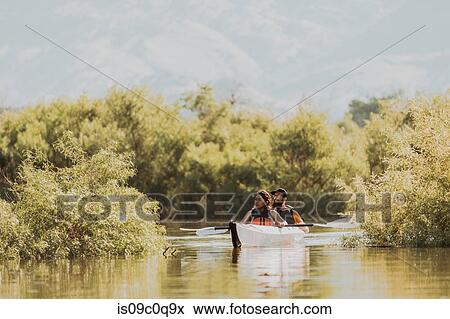 Stock Photo - Friends kayaking in lake, Kaweah, California, United States. Fotosearch
