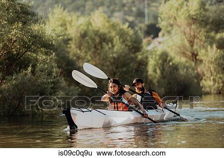 Stock Photograph - Friends kayaking in lake, Kaweah, California, United States. Fotosearch