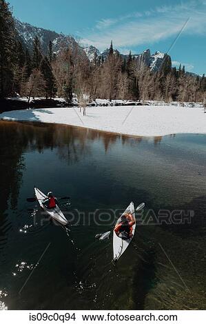 Friends kayaking in lake, Yosemite Village, California, United States View Large Photo Image Picture - Friends kayaking in lake, Yosemite Village, California, United States. Fotosearch