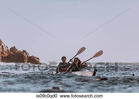 Stock Image - Friends kayaking in sea, Big Sur, California, United States. Fotosearch