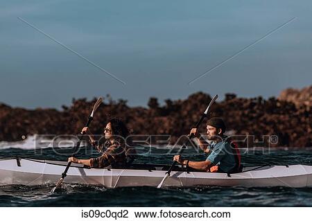 Stock Image - Friends kayaking in sea, Big Sur, California, United States. Fotosearch