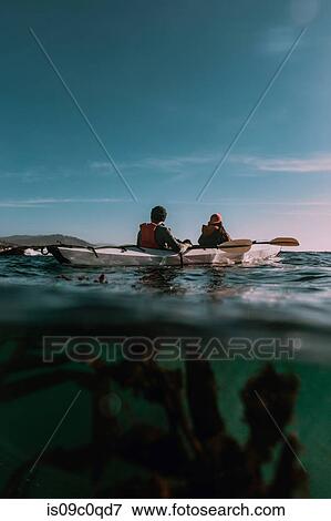 Stock Photo - Friends kayaking in sea, Big Sur, California, United States. Fotosearch