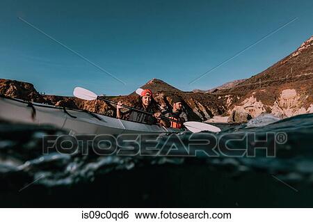 Stock Photograph - Friends kayaking in sea, Big Sur, California, United States. Fotosearch