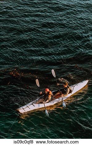 Stock Photo - Friends kayaking in sea. Fotosearch