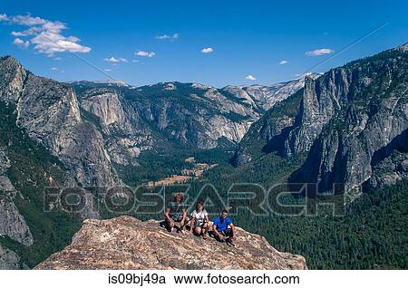 Stock Image - Friends on top of Higher Cathedral Spire, Yosemite Valley, California, United States. Fotosearch