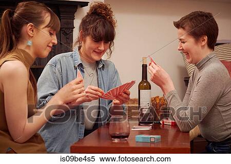 Friends playing cards in living room View Large Photo Image Stock Photography - Friends playing cards in living room. Fotosearch