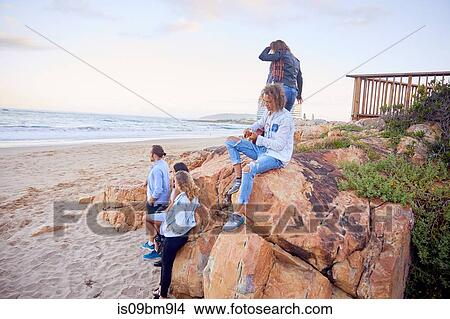Friends relaxing on beach, Plettenberg Bay, Western Cape, South Africa View Large Photo Image Picture - Friends relaxing on beach, Plettenberg Bay, Western Cape, South Africa. Fotosearch