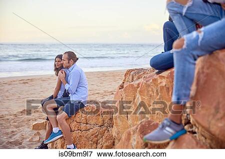 Friends relaxing on beach, Plettenberg Bay, Western Cape, South Africa View Large Photo Image Stock Photo - Friends relaxing on beach, Plettenberg Bay, Western Cape, South Africa. Fotosearch