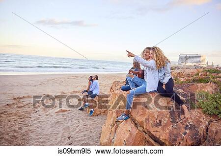 Friends relaxing on beach, Plettenberg Bay, Western Cape, South Africa View Large Photo Image Stock Photography - Friends relaxing on beach, Plettenberg Bay, Western Cape, South Africa. Fotosearch