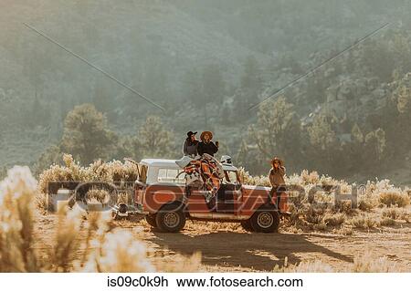 Friends sitting on rooftop of off road vehicle, Kennedy Meadows, California, US View Large Photo Image Stock Image - Friends sitting on rooftop of off road vehicle, Kennedy Meadows, California, US. Fotosearch