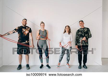 Friends taking break from workout in studio View Large Photo Image Picture - Friends taking break from workout in studio. Fotosearch