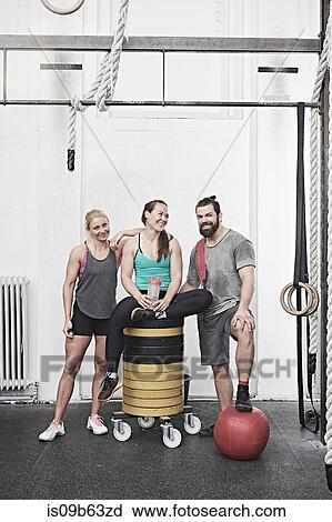 Friends taking break in cross training gym View Large Photo Image Stock Image - Friends taking break in cross training gym. Fotosearch