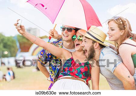 Friends taking selfie at festival View Large Photo Image Stock Image - Friends taking selfie at festival. Fotosearch