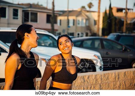 Friends talking by beach, Long Beach, California, US View Large Photo Image Stock Photo - Friends talking by beach, Long Beach, California, US. Fotosearch