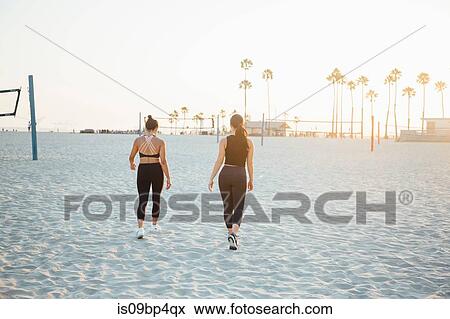 Friends walking on beach, Long Beach, California, US View Large Photo Image Stock Photo - Friends walking on beach, Long Beach, California, US. Fotosearch