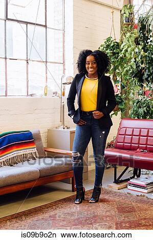 Picture - Full length portrait of woman looking at camera smiling. Fotosearch
