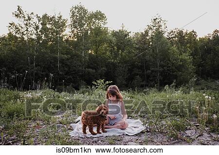 Girl and puppy on picnic blanket View Large Photo Image Picture - Girl and puppy on picnic blanket. Fotosearch
