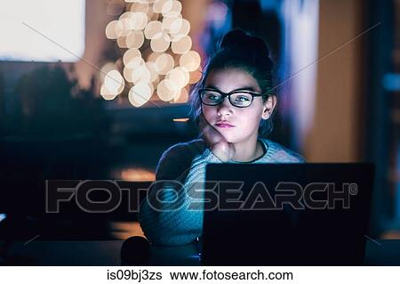 Girl daydreaming in front of laptop at home View Large Photo Image Stock Photograph - Girl daydreaming in front of laptop at home. Fotosearch