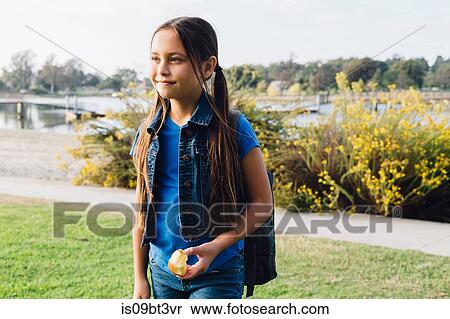 Girl enjoying apple, Long Beach, California, US View Large Photo Image Stock Photography - Girl enjoying apple, Long Beach, California, US. Fotosearch