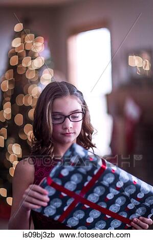 Girl holding Christmas gift View Large Photo Image Stock Image - Girl holding Christmas gift. Fotosearch
