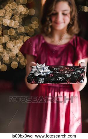 Girl holding Christmas gift View Large Photo Image Stock Photography - Girl holding Christmas gift. Fotosearch
