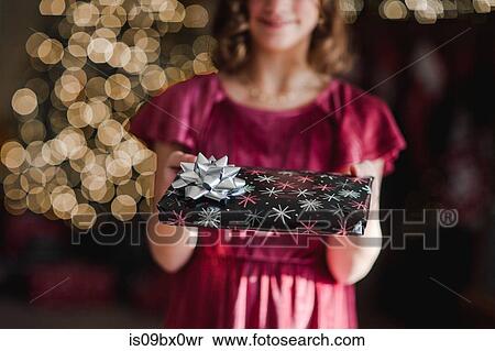 Girl holding Christmas gift View Large Photo Image Stock Photography - Girl holding Christmas gift. Fotosearch