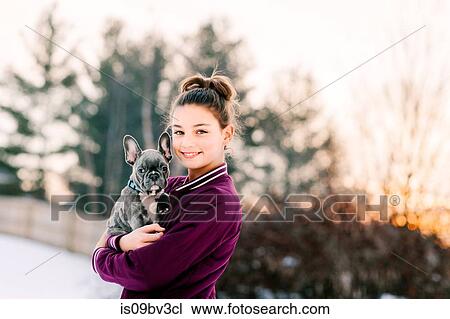 Girl hugging french bulldog puppy outdoors View Large Photo Image Stock Image - Girl hugging french bulldog puppy outdoors. Fotosearch