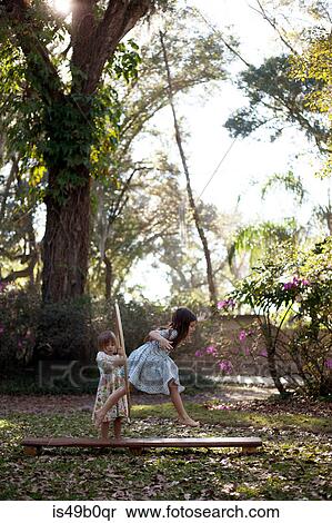 Stock Photography - Girl in dress running through plastic hoop. Fotosearch