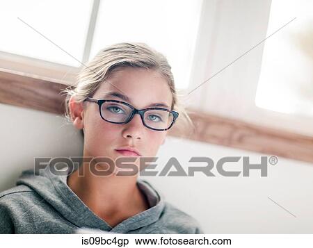 Stock Photography - Girl in spectacles, portrait at home. Fotosearch