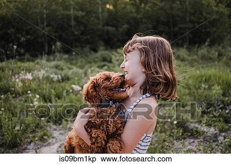 Girl laughing at puppy's kisses View Large Photo Image Stock Photography - Girl laughing at puppy's kisses. Fotosearch