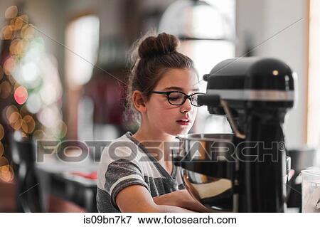 Girl mixing christmas cookie dough in food processor at kitchen counter View Large Photo Image Stock Photo - Girl mixing christmas cookie dough in food processor at kitchen counter. Fotosearch