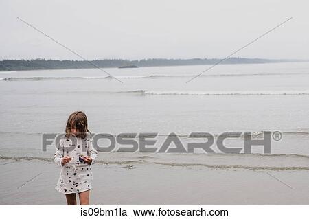 Girl on beach, Tofino, Canada View Large Photo Image Stock Image - Girl on beach, Tofino, Canada. Fotosearch