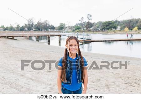 Stock Photograph - Girl on sandy beach, Long Beach, California, US. Fotosearch