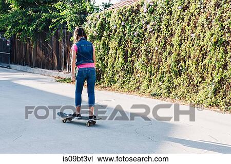 Girl on skateboard View Large Photo Image Stock Image - Girl on skateboard. Fotosearch